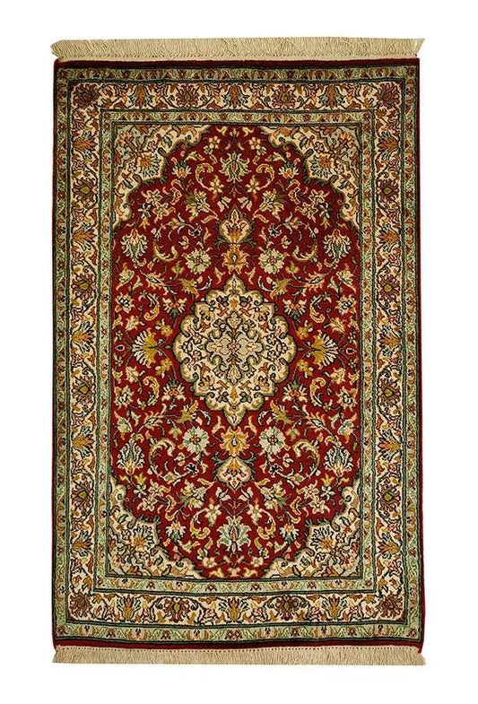 Persian-inspired red and beige rug with intricate floral pattern and central medallion, surrounded by an ornate border, adding a touch of elegance to home decor.