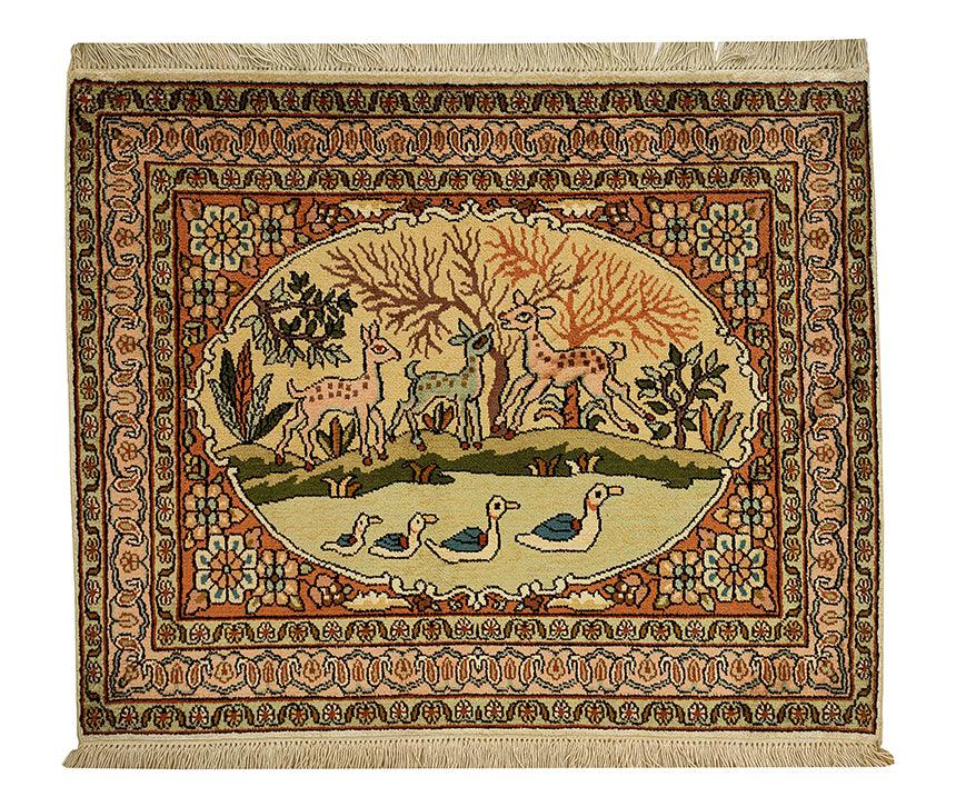 Hand-knotted Persian rug featuring a central oval medallion with a pastoral scene of deer and ducks, surrounded by a floral border.